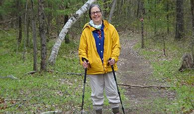 Marjorie Turner Hollman, '77, on a hike in the woods.